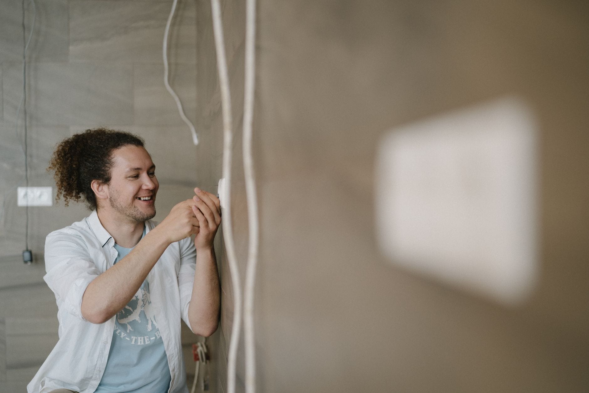 Electrician installing a wall outlet in a residential renovation