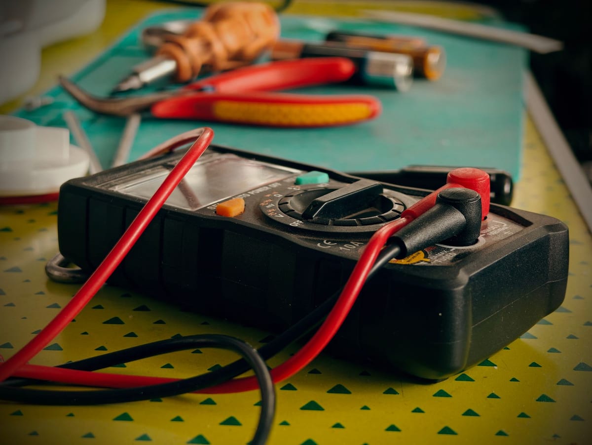 Multimeter and electrical hand tools on a workbench